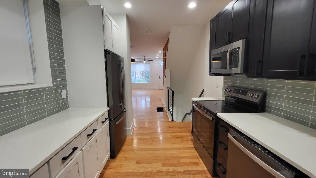 1237 South 27th Street Philadelphia, PA 19146 - Photo 12 of 36 a kitchen with stainless steel appliances a sink stove and refrigerator