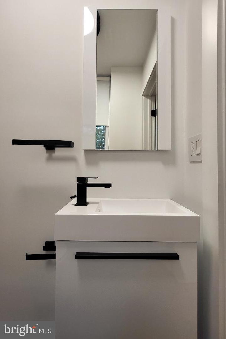 1237 South 27th Street Philadelphia, PA 19146 - Photo 15 of 36 a bathroom with a sink a mirror and a vanity