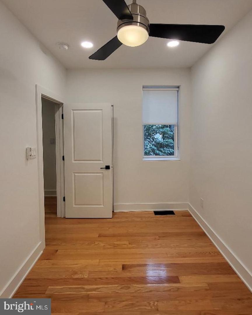 1237 South 27th Street Philadelphia, PA 19146 - Photo 19 of 36 an empty room with wooden floor closet and windows