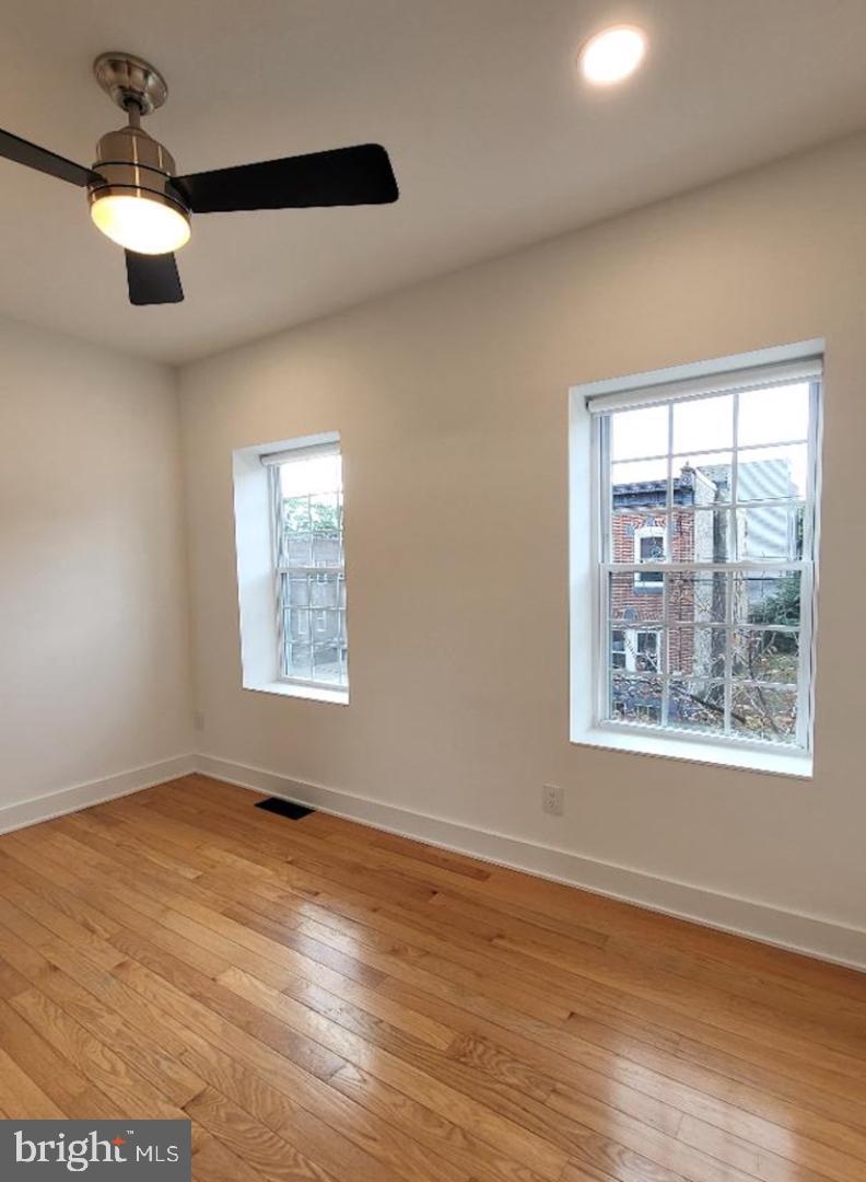 1237 South 27th Street Philadelphia, PA 19146 - Photo 20 of 36 a view of an empty room with wooden floor and a window
