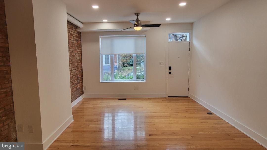 1237 South 27th Street Philadelphia, PA 19146 - Photo 2 of 36 an empty room with wooden floor and windows