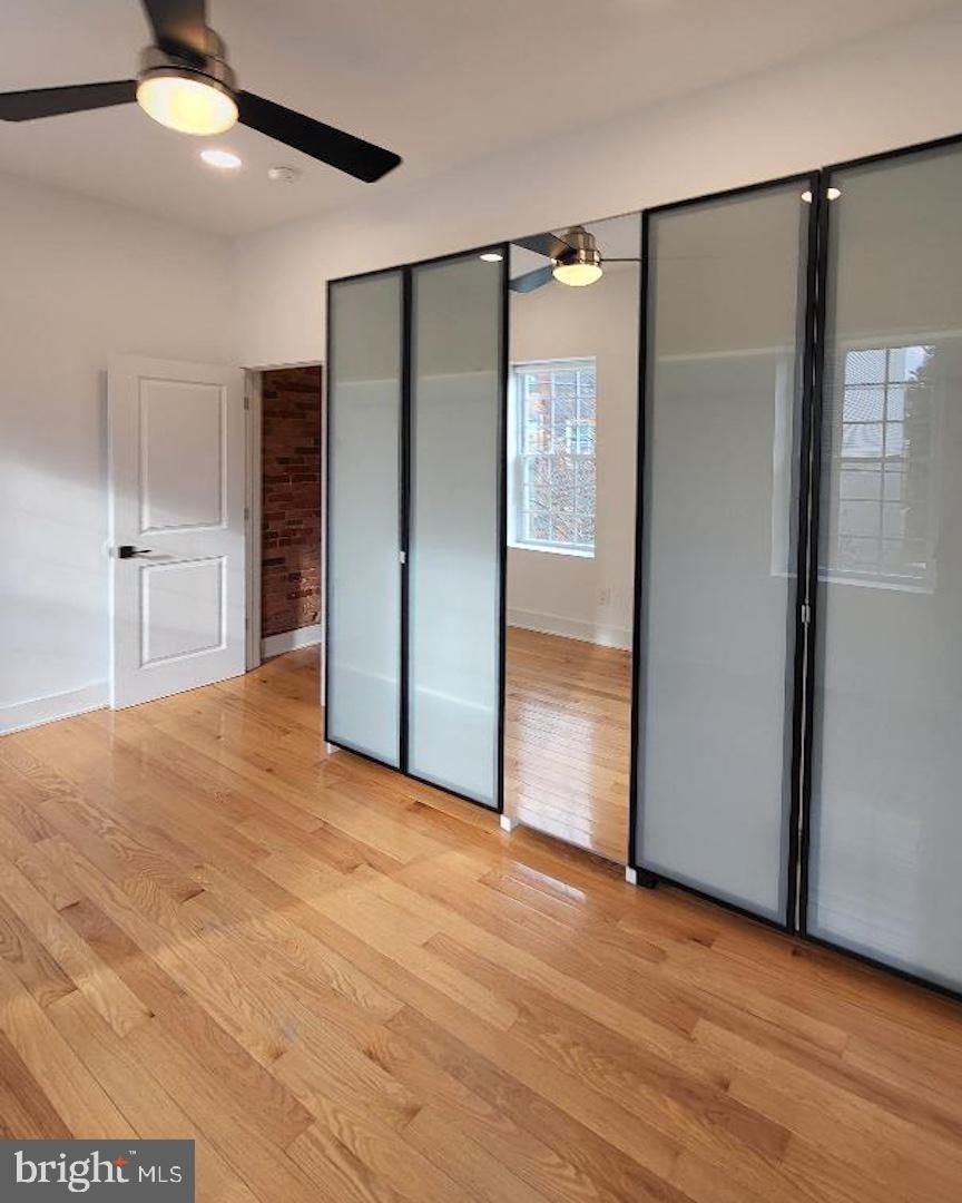 1237 South 27th Street Philadelphia, PA 19146 - Photo 21 of 36 an empty room with wooden floor and a ceiling fan
