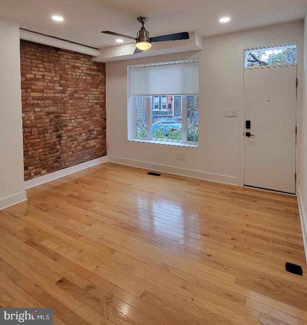 1237 South 27th Street Philadelphia, PA 19146 - Photo 3 of 36 a view of an empty room with wooden floor and a window