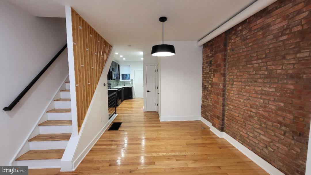 1237 South 27th Street Philadelphia, PA 19146 - Photo 4 of 36 a view of a hallway with wooden floor and staircase