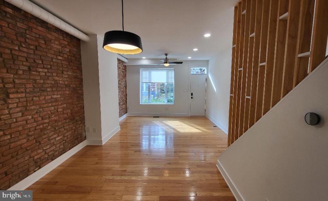 1237 South 27th Street Philadelphia, PA 19146 - Photo 6 of 36 a view of a hallway with wooden floor and chandelier