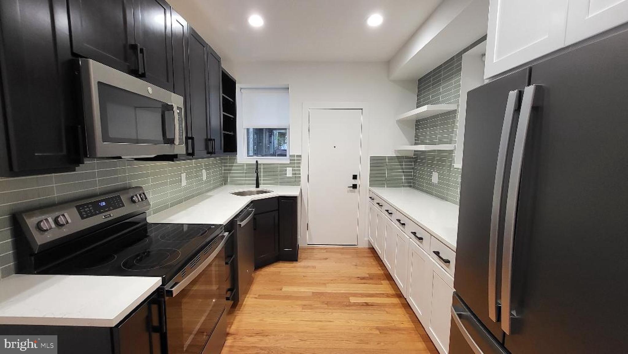 1237 South 27th Street Philadelphia, PA 19146 - Photo 8 of 36 a kitchen with stainless steel appliances a sink stove and refrigerator