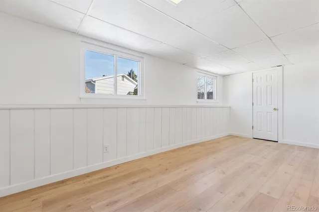 a view of empty room with wooden floor