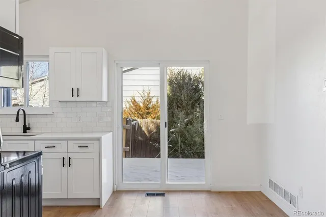 a kitchen with white cabinets and a sink