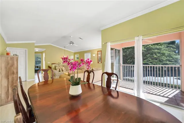 a dining room with furniture and a floor to ceiling window