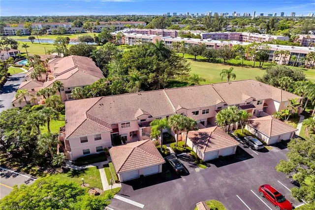 an aerial view of multiple houses with yard