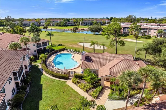 a view of a swimming pool with a table and chairs