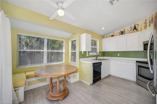 a kitchen with sink cabinets and dining table