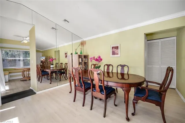a view of a dining room with furniture and chandelier