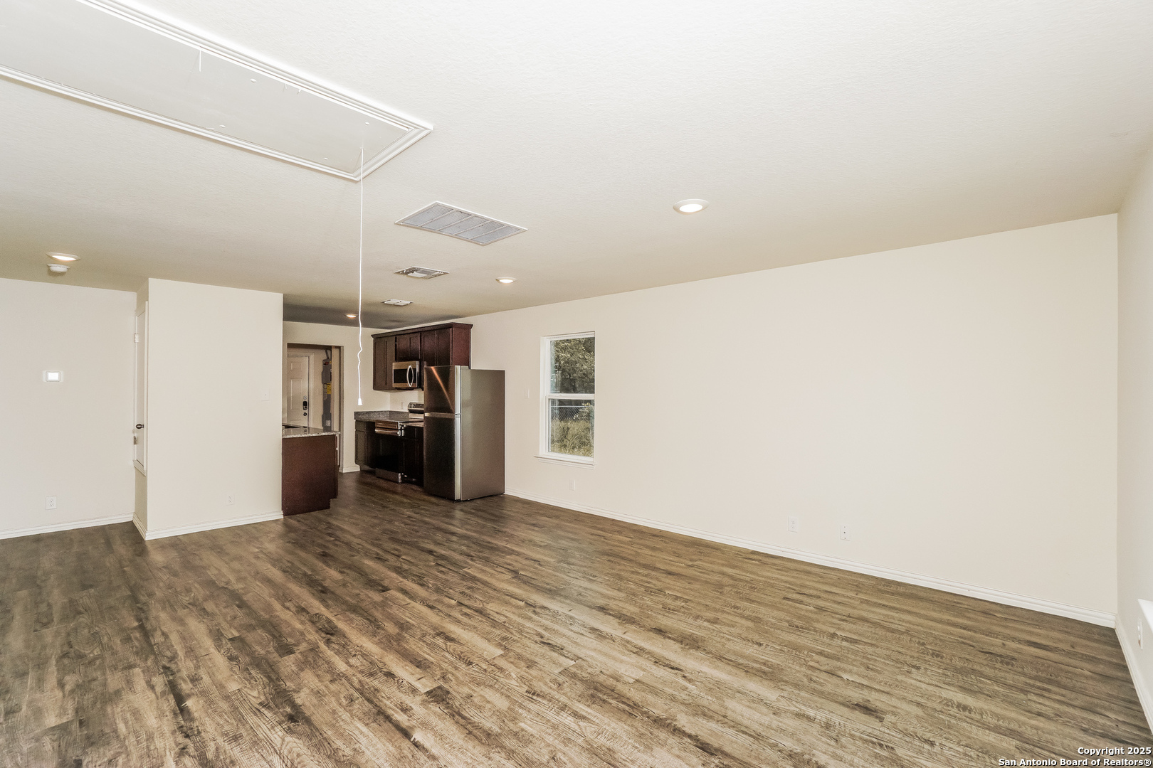 527 Elley Street Seguin, TX 78155 - Photo 4 of 21 a view of a kitchen with a refrigerator and a window