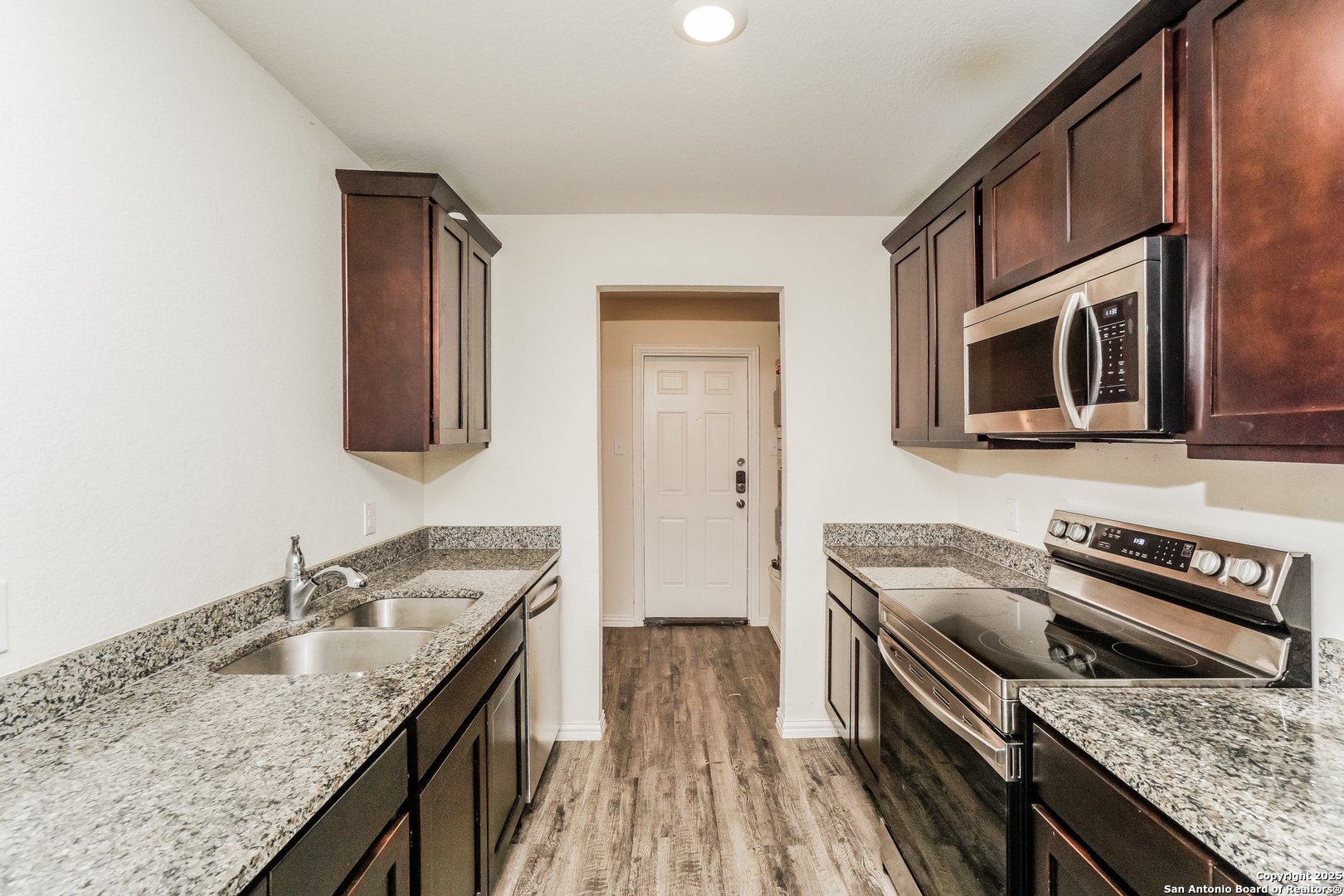 527 Elley Street Seguin, TX 78155 - Photo 9 of 21 a kitchen with a stove sink and microwave
