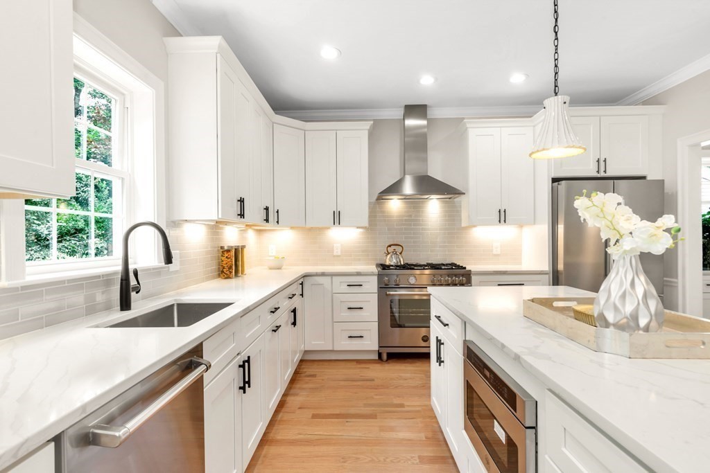 14 Yerxa Road Arlington, MA 02474 - Photo 12 of 42 a large white kitchen with a stove and a sink