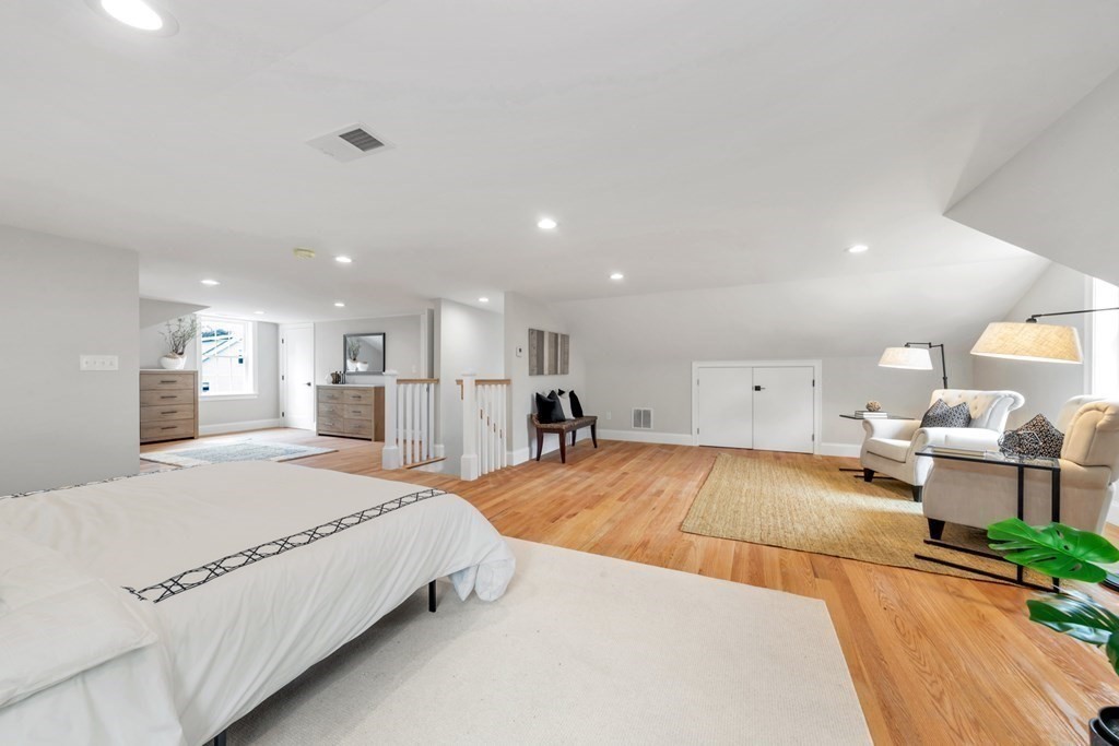14 Yerxa Road Arlington, MA 02474 - Photo 20 of 42 a large bedroom with a bed and a large mirror on the table