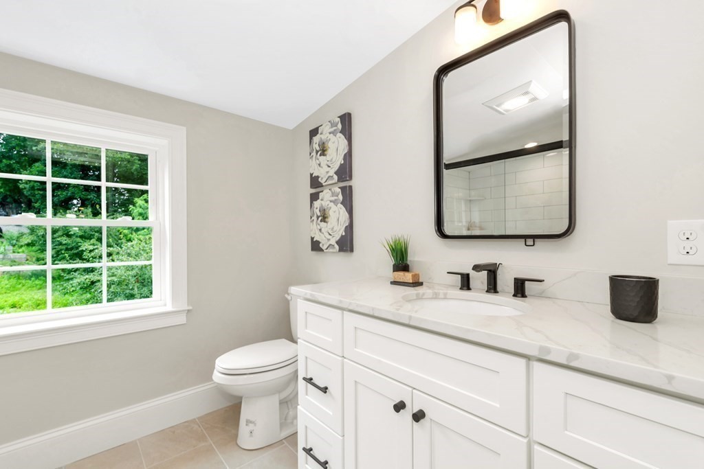 14 Yerxa Road Arlington, MA 02474 - Photo 24 of 42 a bathroom with a toilet a sink and a mirror