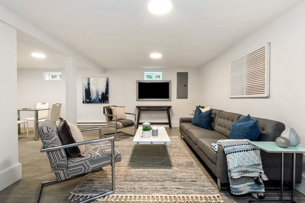 14 Yerxa Road Arlington, MA 02474 - Photo 32 of 42 a living room with furniture and a flat screen tv