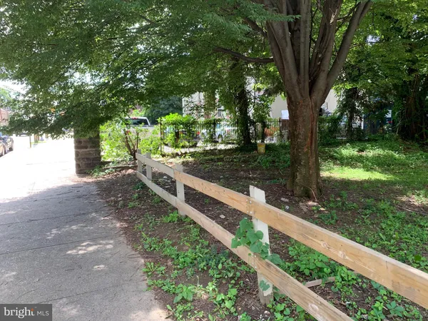 a view of a backyard with wooden fence