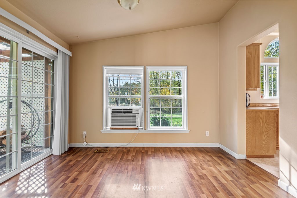 207 Apple Creek Road Longview, WA 98632 - Photo 9 of 33 an empty room with wooden floor and windows
