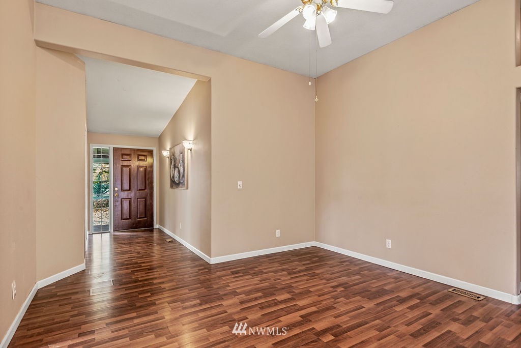 207 Apple Creek Road Longview, WA 98632 - Photo 10 of 33 a view of a room with wooden floor and a ceiling fan