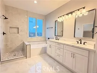 a bathroom with a double vanity sink mirror and shower
