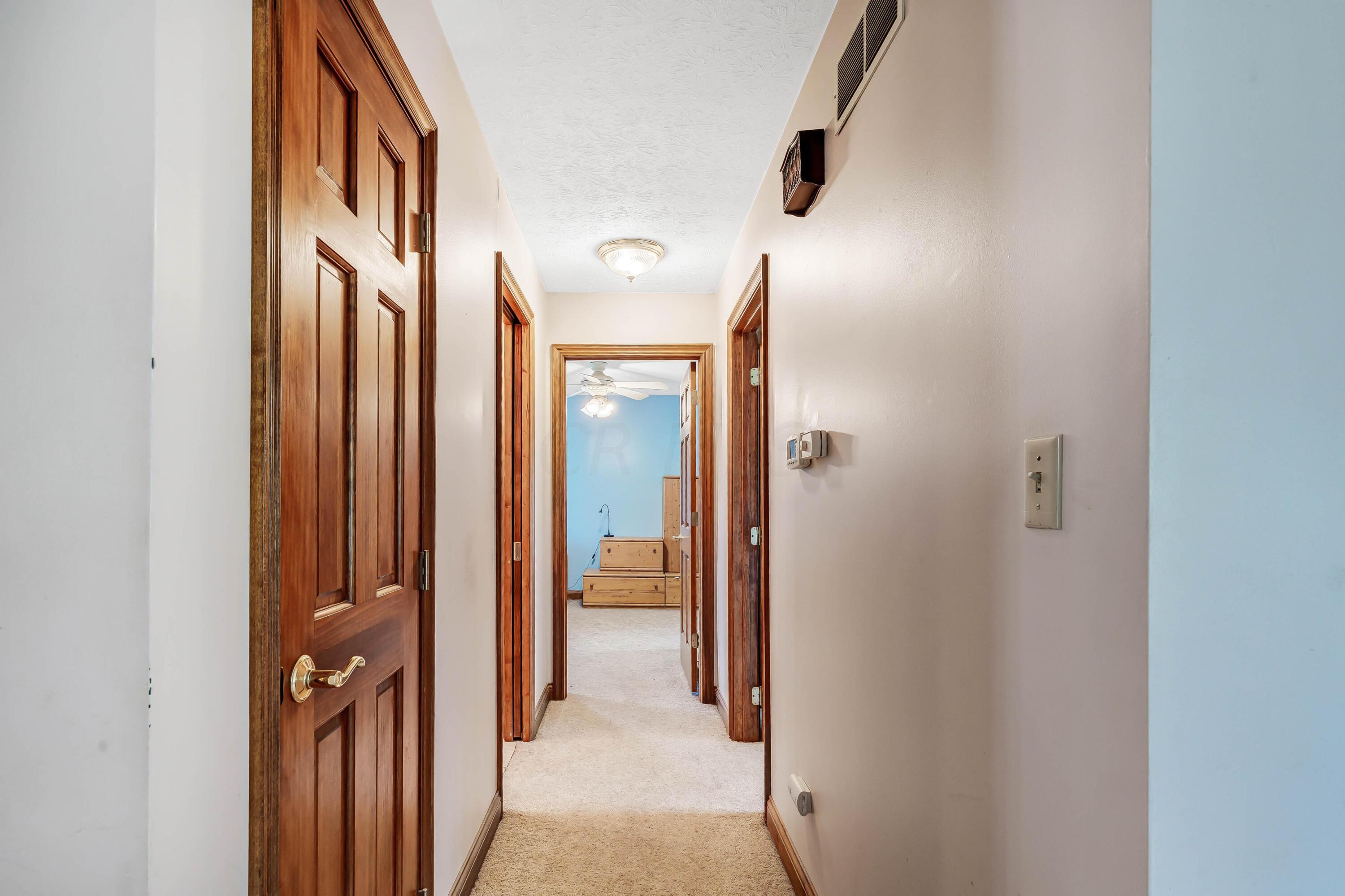 8558 Morris Road Hilliard, OH 43026 - Photo 6 of 74 • Tan carpet • Ivory painted walls • Linen closet • Ceiling light
