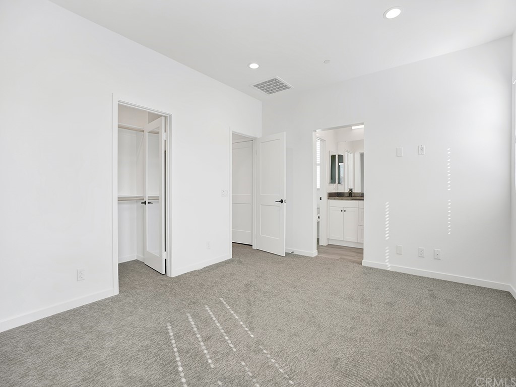 524 Caleigh Lane Costa Mesa, CA 92627 - Photo 13 of 19 an empty room with white cabinet and mirrors