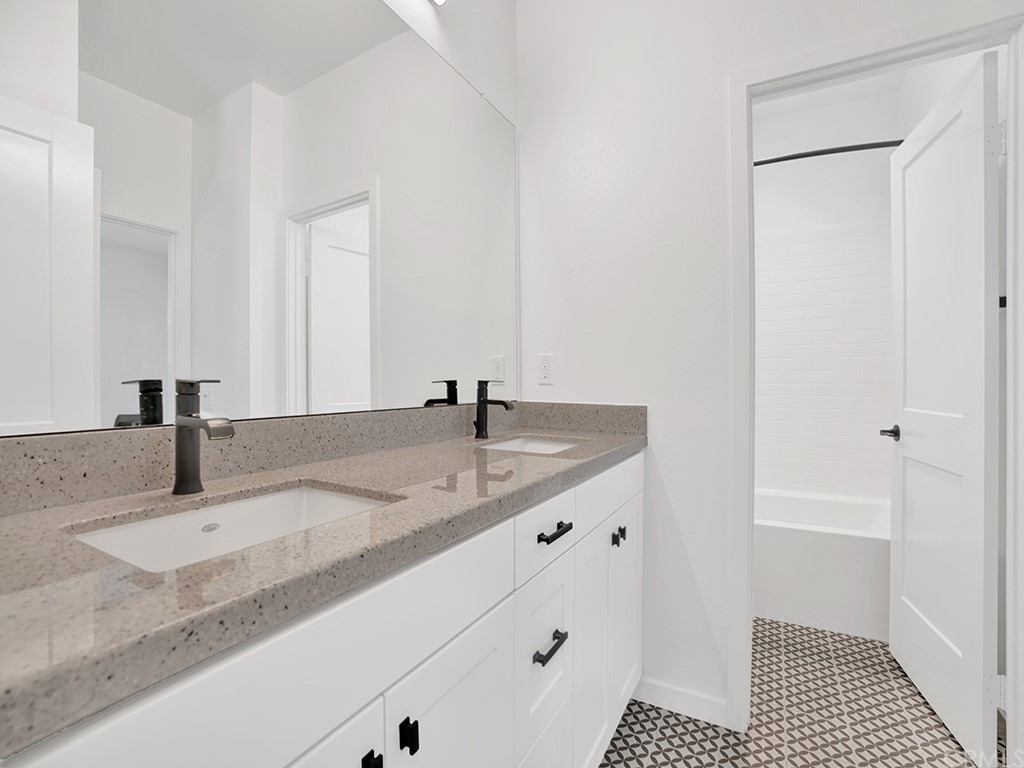524 Caleigh Lane Costa Mesa, CA 92627 - Photo 18 of 19 a bathroom with a granite countertop sink and a mirror