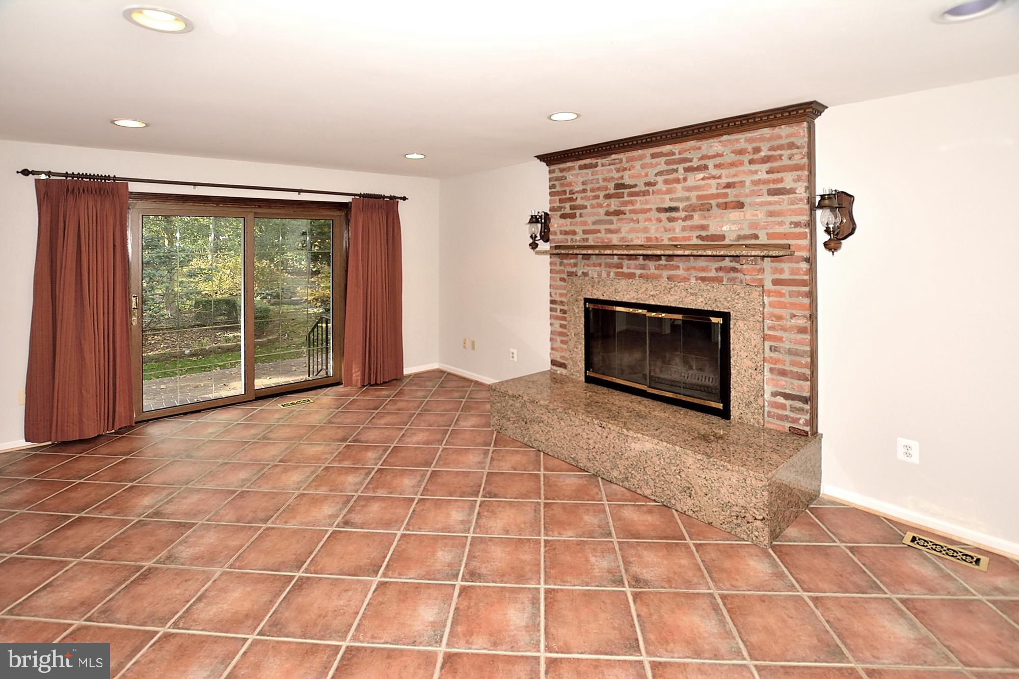 11093 Robert Carter Road Fairfax Station, VA 22039 - Photo 12 of 30 a view of empty room with wooden floor and fireplace