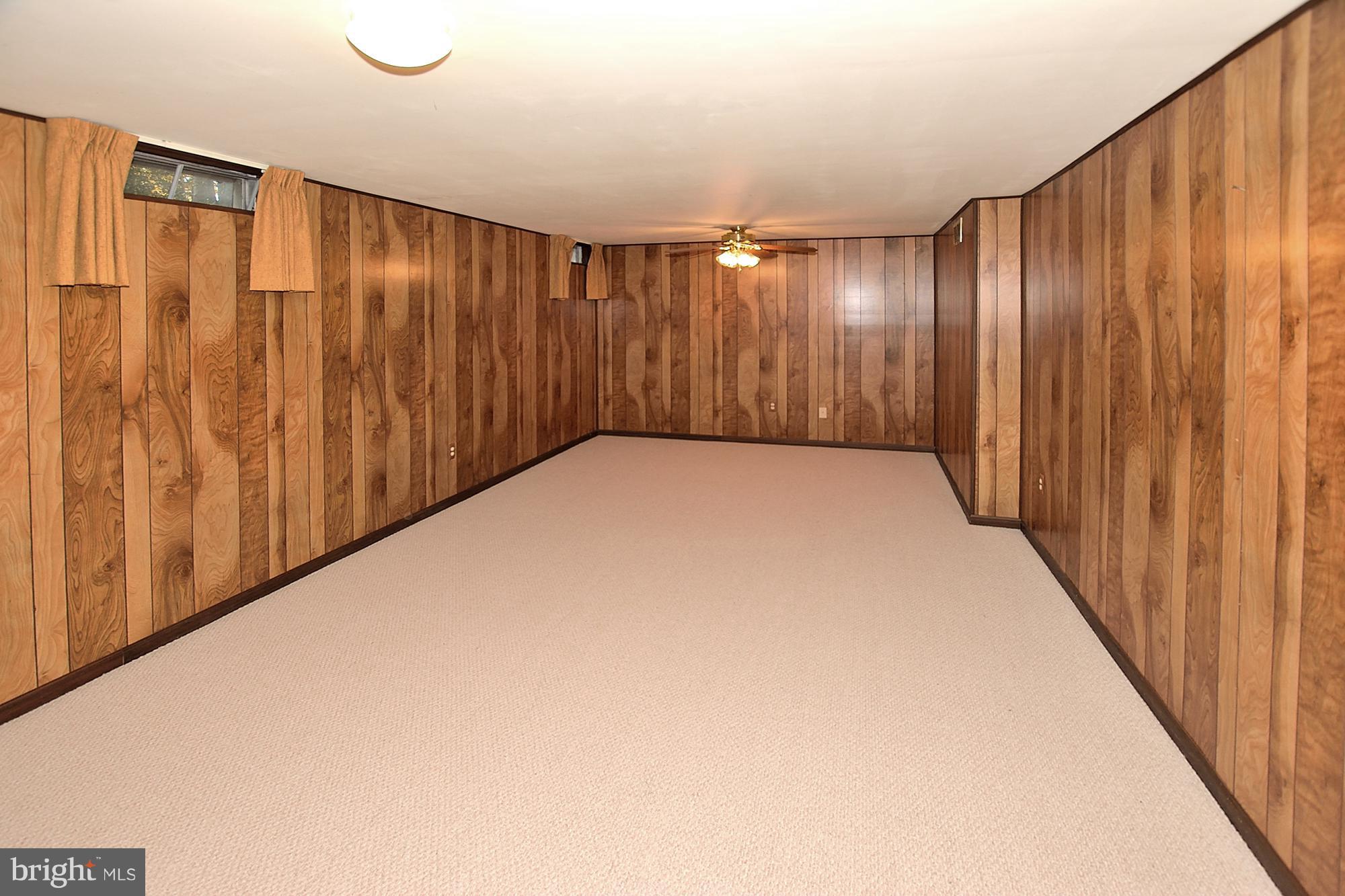 11093 Robert Carter Road Fairfax Station, VA 22039 - Photo 22 of 30 a view of an empty room with wooden walls