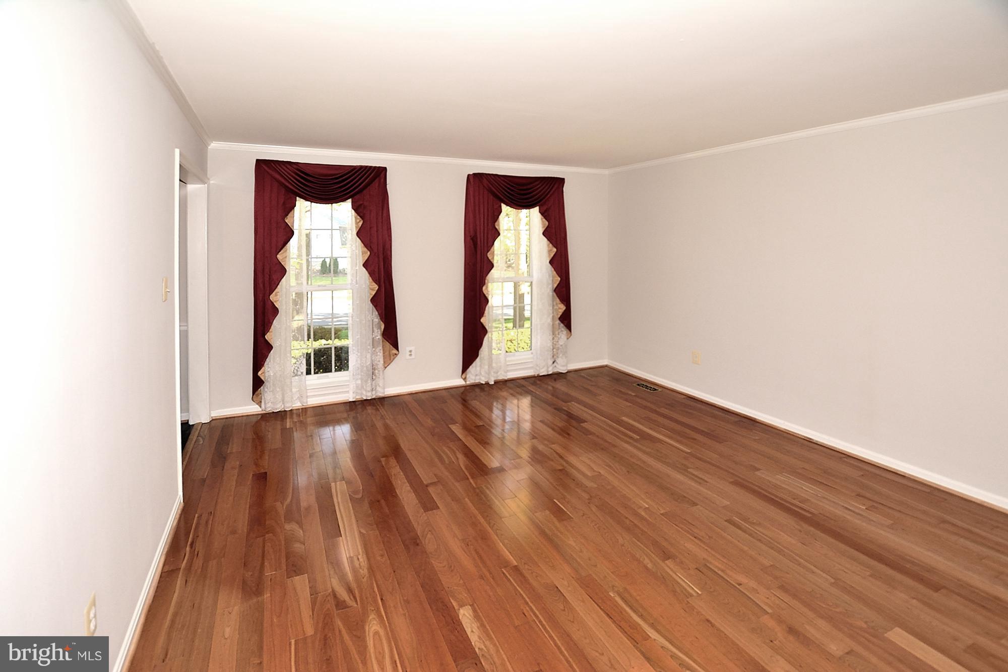 11093 Robert Carter Road Fairfax Station, VA 22039 - Photo 3 of 30 an empty room with wooden floor and windows