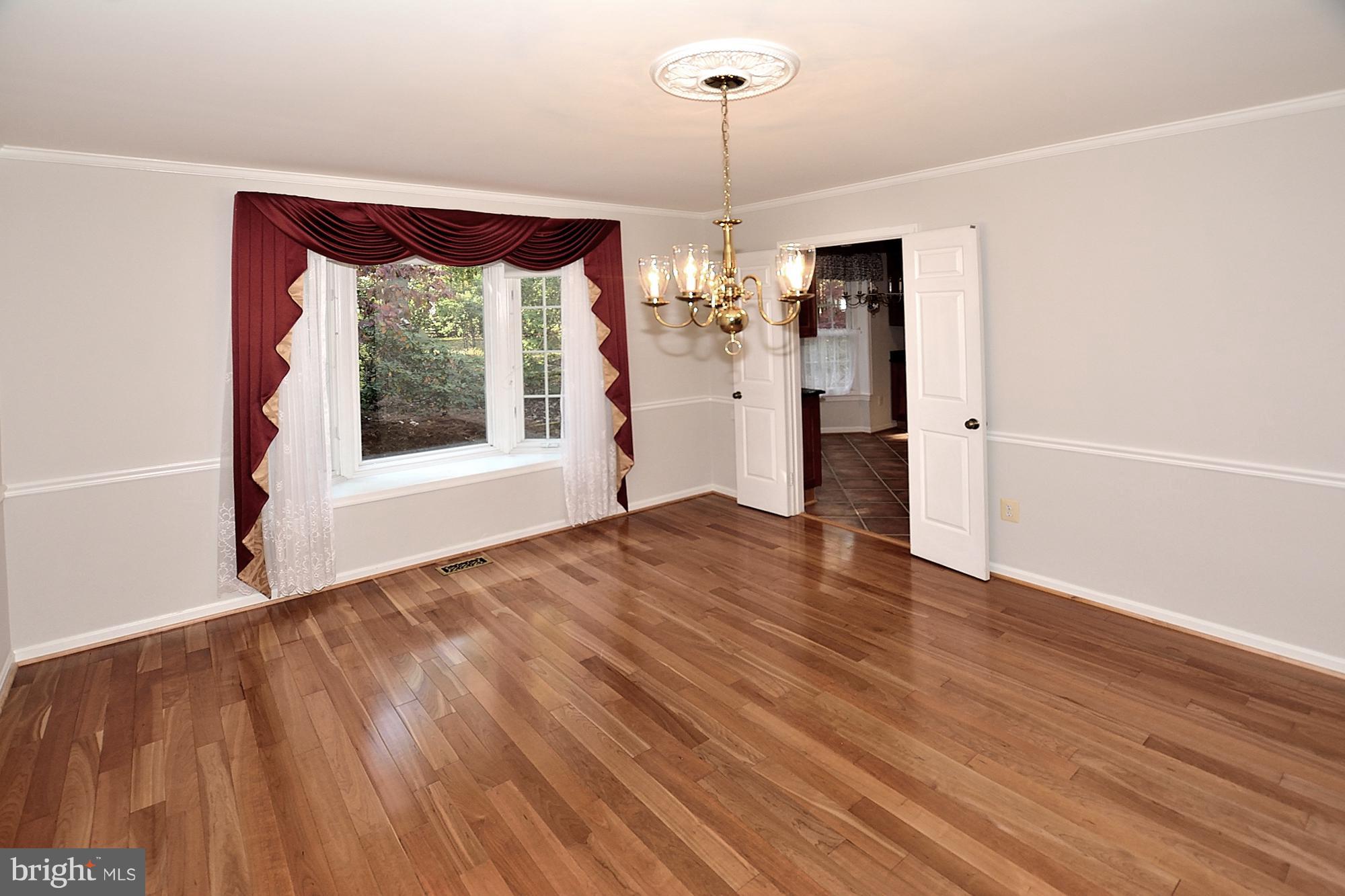 11093 Robert Carter Road Fairfax Station, VA 22039 - Photo 4 of 30 a view of an empty room with a window and wooden floor