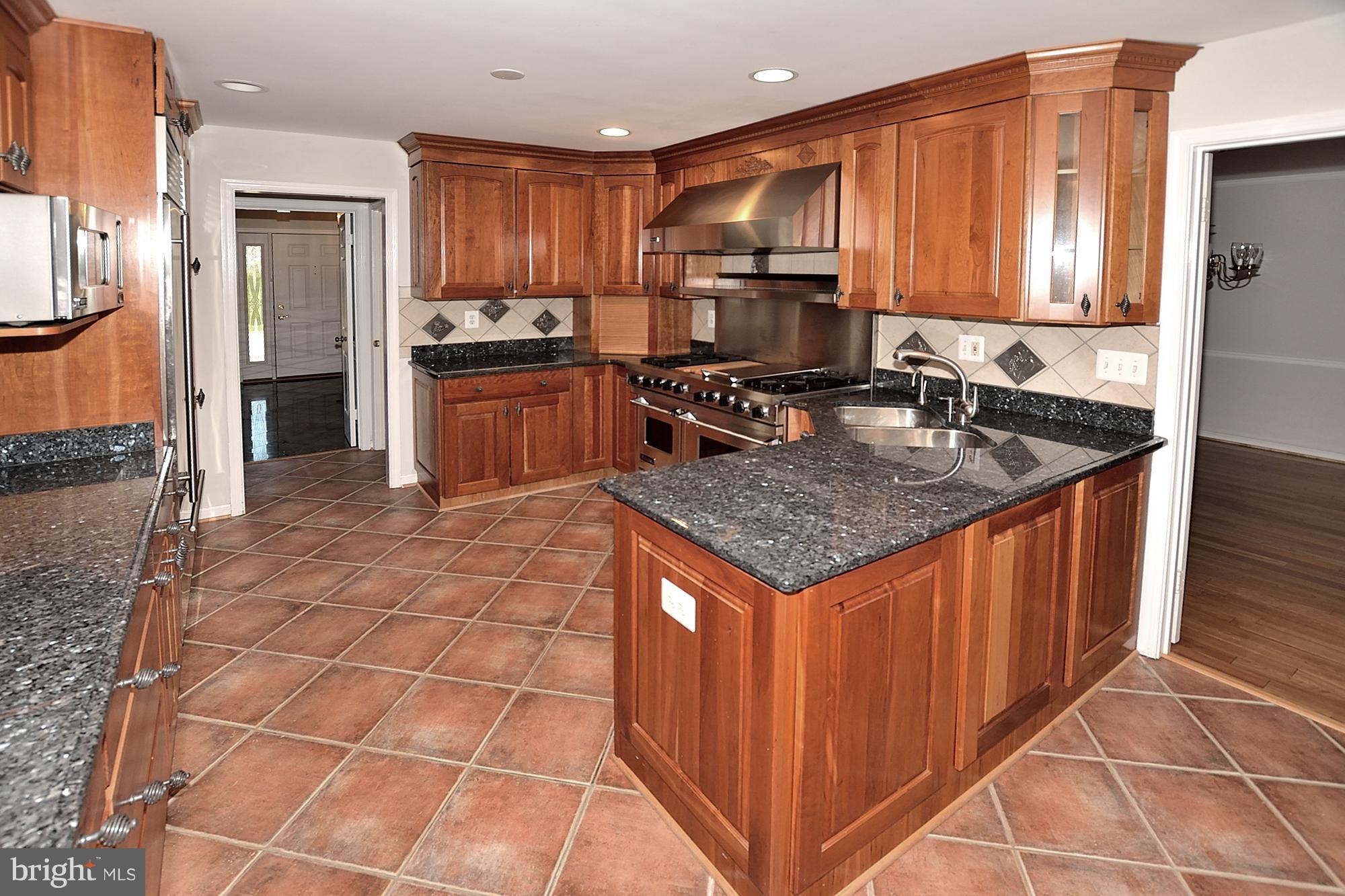 11093 Robert Carter Road Fairfax Station, VA 22039 - Photo 5 of 30 a kitchen with stainless steel appliances granite countertop a stove a sink and a microwave