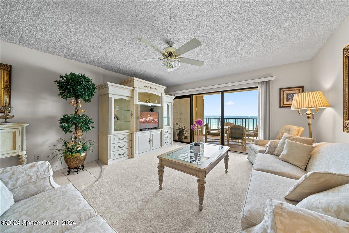 2725 North Hwy A1A, Unit 403 Indialantic, FL 32903 - Photo 13 of 37 a living room with furniture and a large window