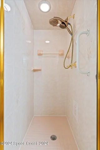 a bathroom with a bath tub with a shower