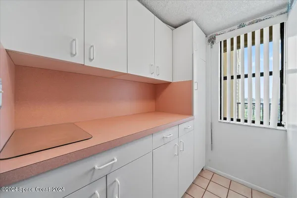 a view of a kitchen with white cabinets