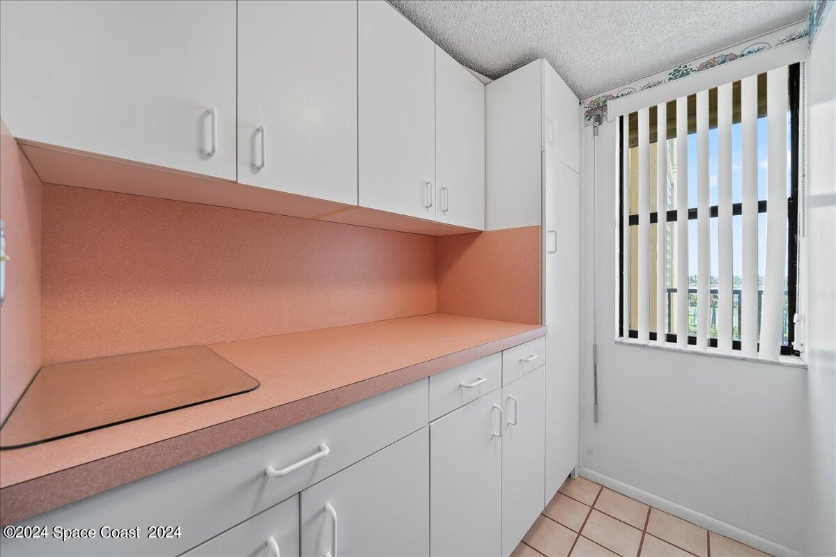 2725 North Hwy A1A, Unit 403 Indialantic, FL 32903 - Photo 23 of 37 a view of a kitchen with white cabinets