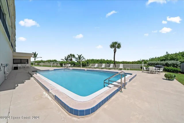 a view of a swimming pool with a lounge chair