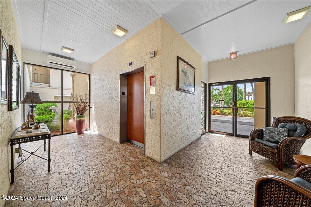 2725 North Hwy A1A, Unit 403 Indialantic, FL 32903 - Photo 30 of 37 a view of a livingroom with furniture and floor to ceiling window