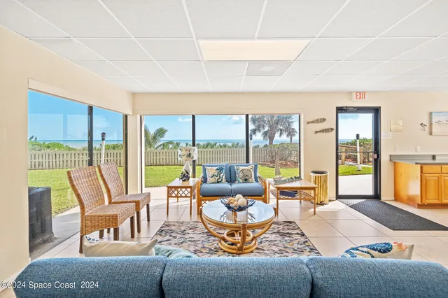 a living room with furniture and large windows