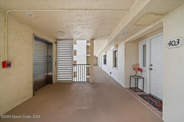 a view of a hallway with stairs