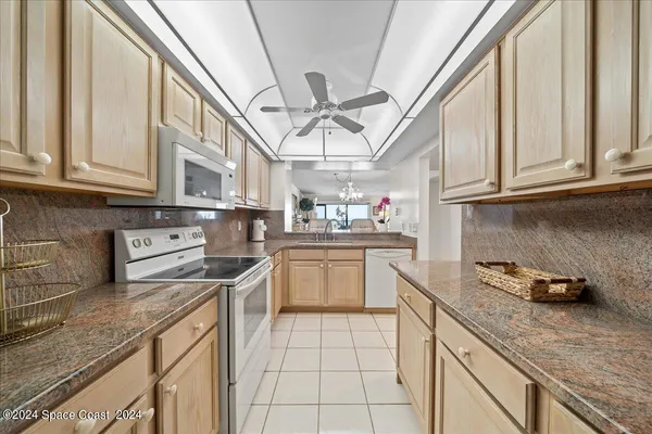 a kitchen with stainless steel appliances granite countertop a sink a stove and cabinets