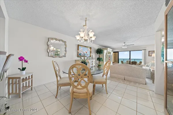 a view of a dining room with furniture and chandelier