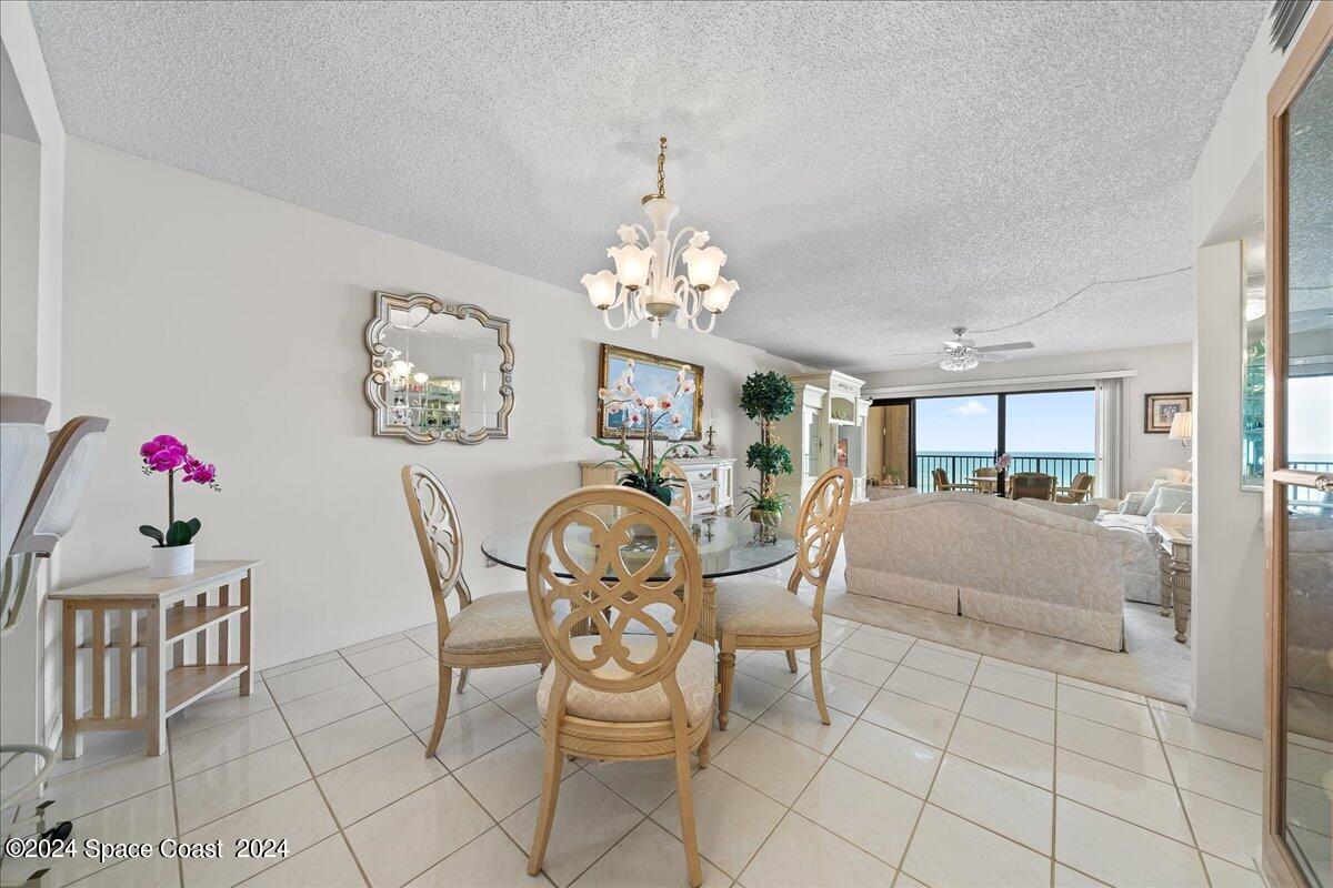 2725 North Hwy A1A, Unit 403 Indialantic, FL 32903 - Photo 9 of 37 a view of a dining room with furniture and chandelier