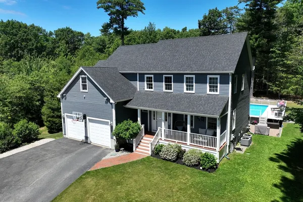 a aerial view of a house with a yard and plants