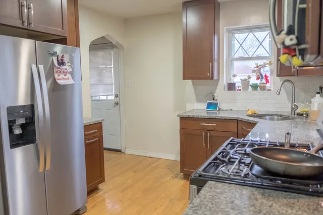 a kitchen with stainless steel appliances granite countertop a refrigerator and a stove