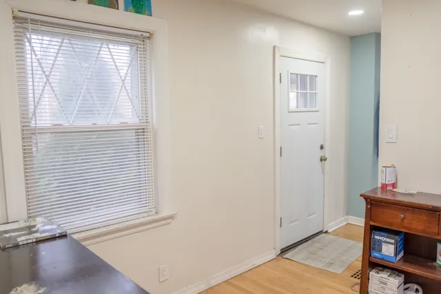 a view of room with window and wooden floor