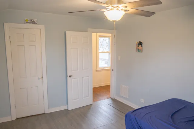 a view of a livingroom with wooden floor and a ceiling fan